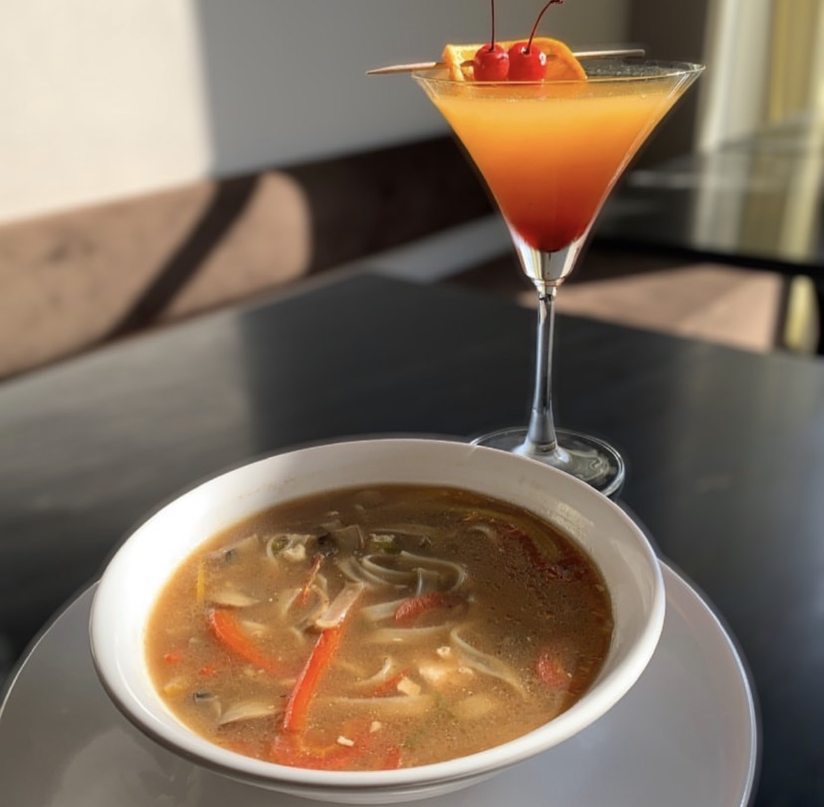 Hot and sour soup with a tequila sunrise mocktail